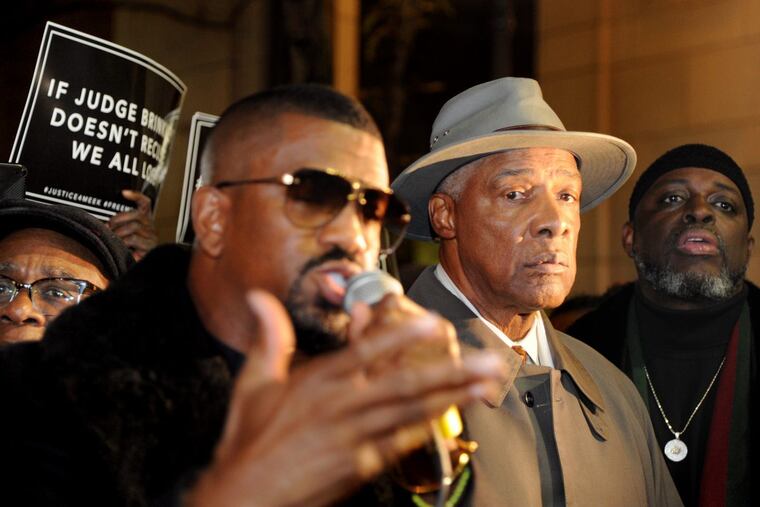 Julius Erving waits to speak at a rally in support of rapper Meek Mill.