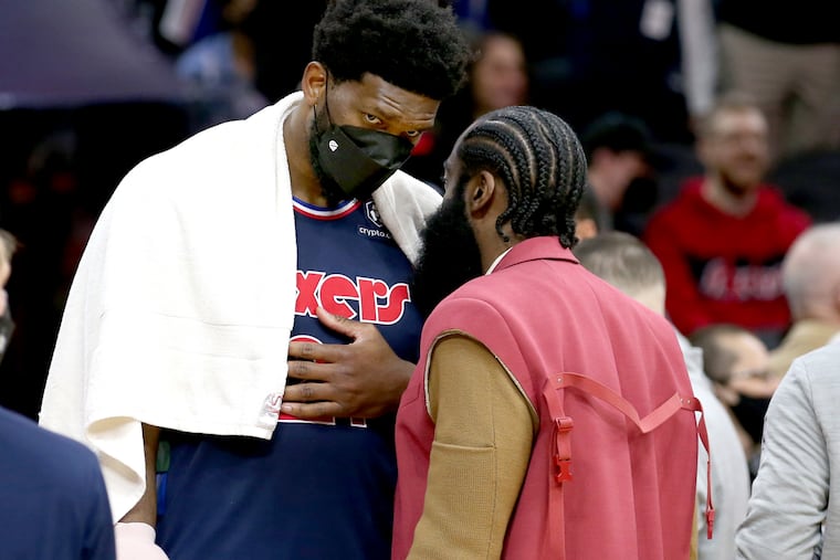 Joel Embiid, left, and James Harden of the Sixers talk during a timeout late in their game against the Celtics at the Wells Fargo Center on Feb. 15, 2022.