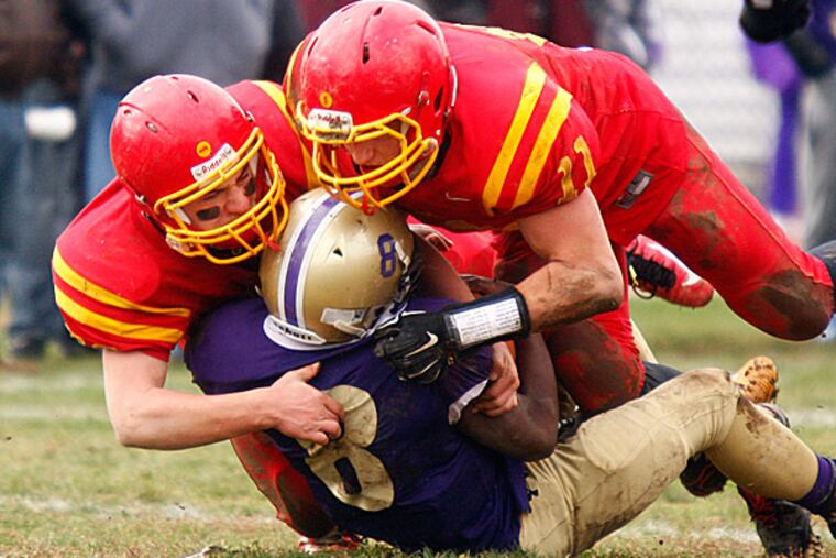 Haverford's Tom Campli (left) and Sam Romanofsky sack Upper Darby quarterback Christoff Minot. (Lou Rabito/Staff)