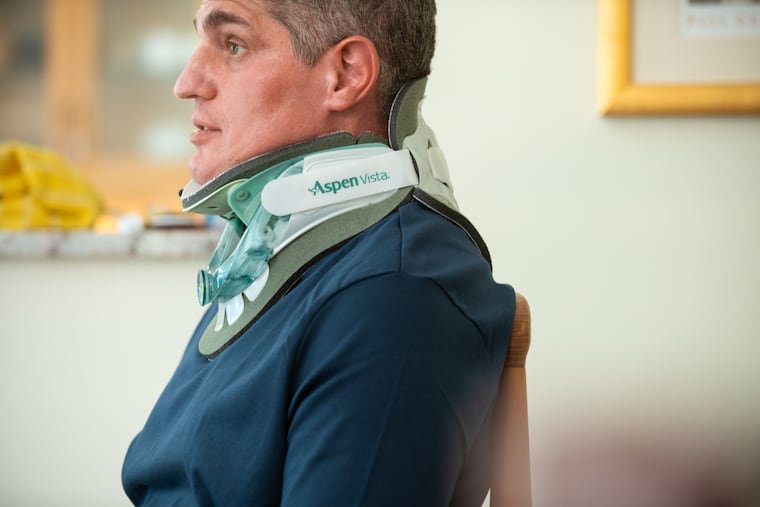 Itamar Drechsler, inside his home in Montgomery County, is still wearing a neck brace after undergoing surgery for a fractured vertebra. He was struck in June by a man riding a high-powered electric cycle.
