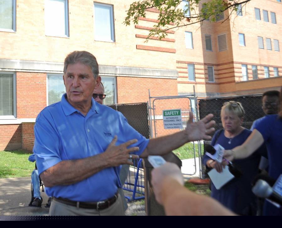 In this Aug. 30, 2019, photo, U.S. Sen. Joe Manchin talks to reporters outside the Louis A. Johnson VA Medical Center in Clarksburg, W.Va. Manchin had called for an expedited investigation into the suspicious deaths at the hospital.
