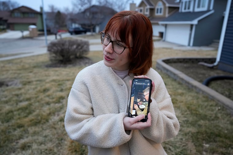 Keira Coady holds a photo of her brother, Sgt. Declan Coady, 20, outside her home Tuesday, in West Des Moines, Iowa.
