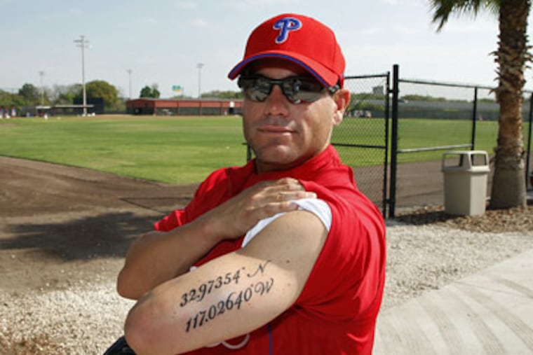 Phillies infielder Marcus Giles shows one of two tattoos Friday that he got earlier in the week to memorialize the death of his infant daughter and the death of his best friend. (Photo by J. Meric)