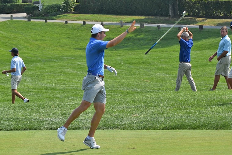 John Peters, an incoming freshman at Duke, joyfully flips his club after holing out a 193-yard approach shot at the 18th hole at Merion Golf Club for an eagle 2 and the victory in the Pennsylvania Amateur.