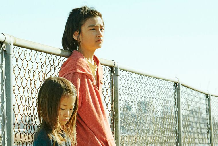 This image released by Magnolia Pictures shows Sasaki Miyu, left, and Jyo Kairi in a scene from "Shoplifters." (Magnolia Pictures via AP)