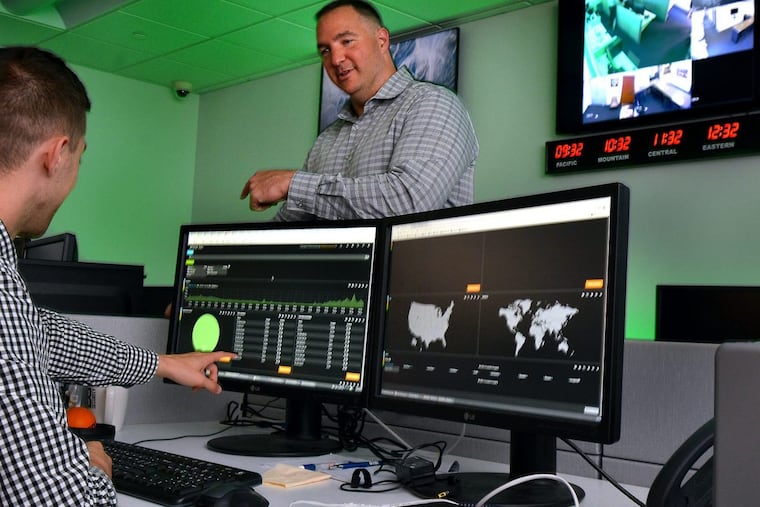 BTB Security Managing Partner Ron Schlecht Jr., center, demonstrates his tools at the company’s base in Bala Cynwyd.