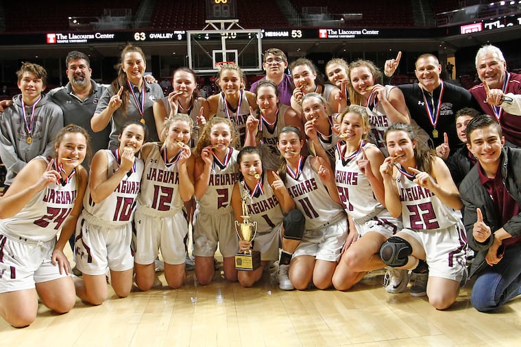 Garnet Valley team members pose with their trophy and medals after winning the District 1 Class 6A girls basketball championship game.