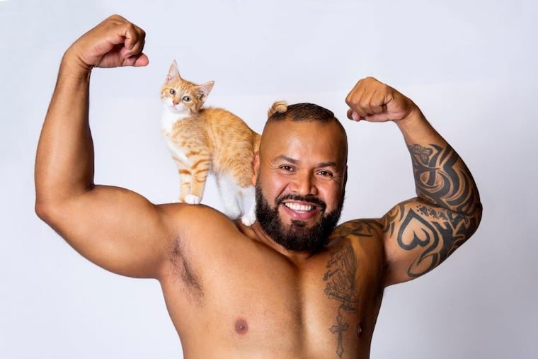 Gustavo Ugarte and kitten in his July month photo in the Hunks for Hounds (and Cats!) 2023 Calendar.