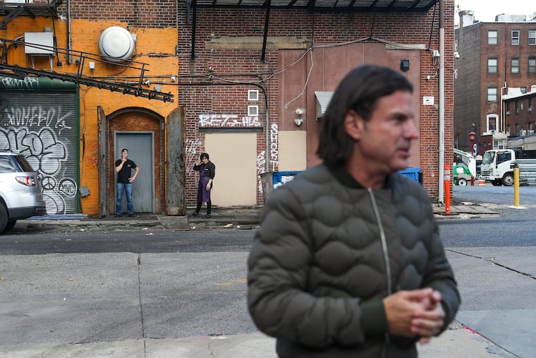 David Adelman, a minority owner of the 76ers, speaks about the development of the proposed new arena while standing behind the Greyhound station at 10th and Filbert Streets.
