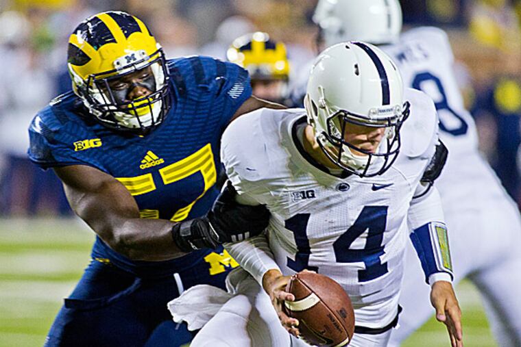 Michigan defensive end Frank Clark sacks Penn State quarterback Christian Hackenberg. (Tony Ding/AP)