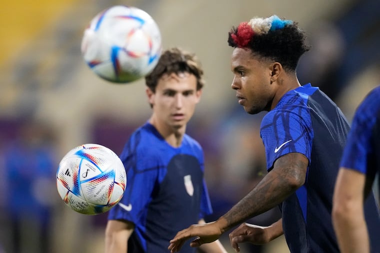 Brenden Aaronson (left) and Weston McKennie (right), with his hair dyed in patriotic colors, at the U.S. men's soccer team's practice on Sunday.