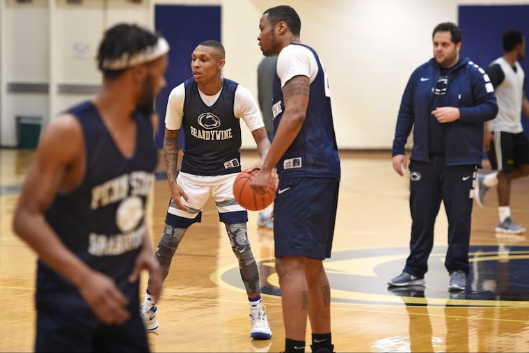 Penn State Brandywine head coach Ben Kay (right) at practice with seniors (from left) James Fisher, Donte Winfield, and Terrence Brown.