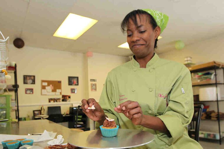 Victoria Andreacchio puts the finishing touches on a cupcake at her V's Cupcakeryin Norristown. Next month, Make Mine a Million $ Business will hold a competitionin which participants make two-minute pitches about their business. The 75 winners will each get a $1,000 gift card and a chance to win even more in a second round.