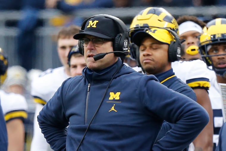 Michigan head coach Jim Harbaugh watches from the sideline during his team's loss to Ohio State last year.