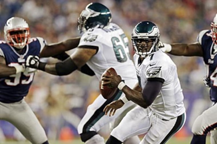 Eagles offensive lineman King Dunlap blocks for Michael Vick during Monday's preseason game. (Elise Amendola/AP)