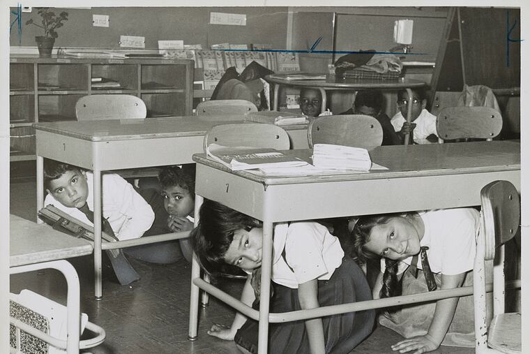 At P.S. 58, located at Carroll and Smith Sts. in Brooklyn, youngsters crawl under their desks as part of a "duck and cover" drill in 1962.