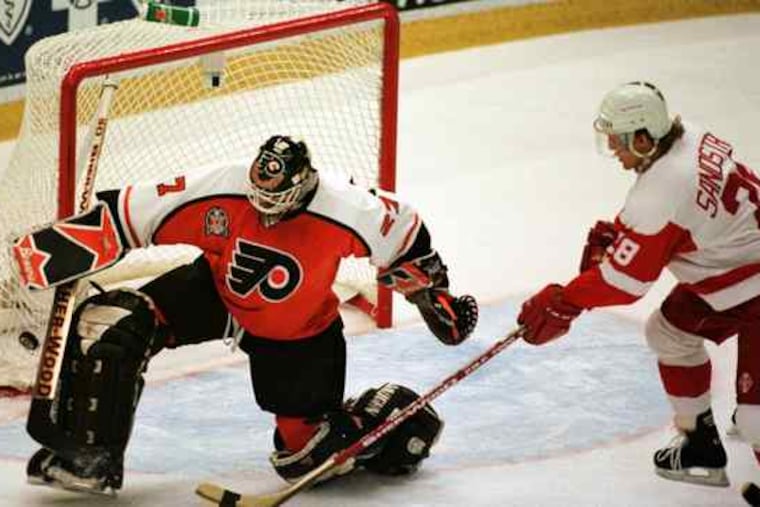 Flyers goalie Ron Hextall, who led the Flyers to the Stanley Cup finals 10 years earlier, kick-saves a shot by Detroit's Tomas Sandstrom in the 1997 finals. The Flyers were swept in four games.