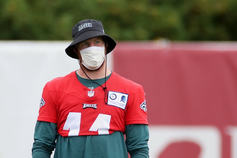 Eagles quarterback Carson Wentz (11) watched his teammates during practice last Tuesday.
