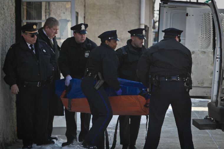 Philadelphia police carry the body of a mid 20's male from the scene of a homicide at Coin Laundromat 53rd and Springfield in southwest Philadelphia on Thursday morning, Feb. 19, 2015. (Alejandro A.
Alvarez / Staff Photographer)