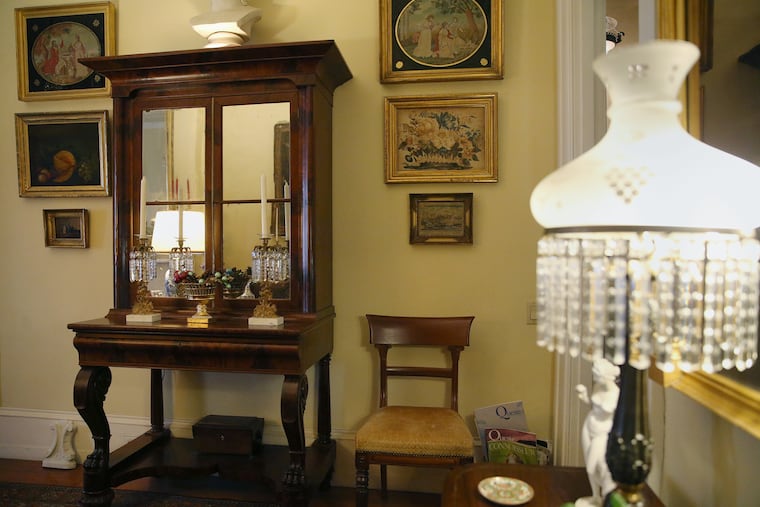 Jack Murray's living room is filled with antiques, including a secretary desk, circa 1820s, made by Anthony Quervelle.