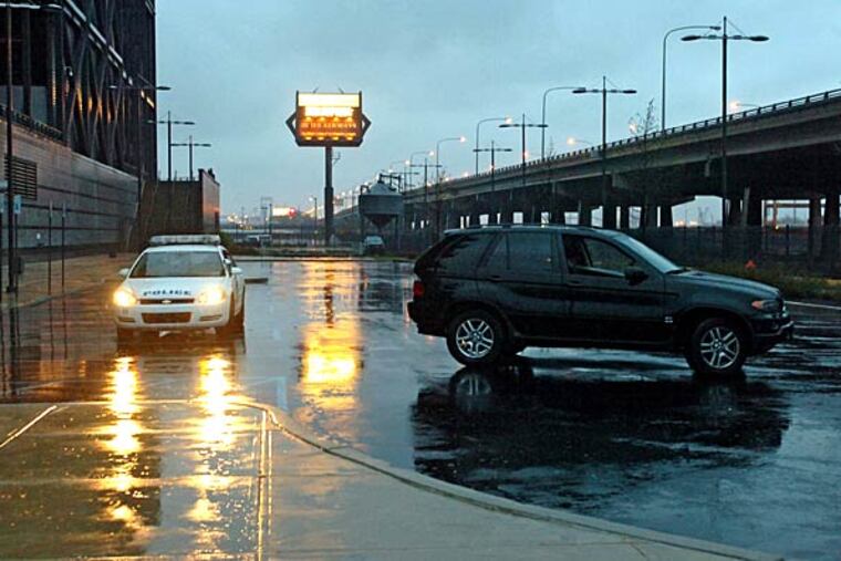 Police on the scene at Lincoln Financial Field guard the suspects' car on the south side of the stadium.