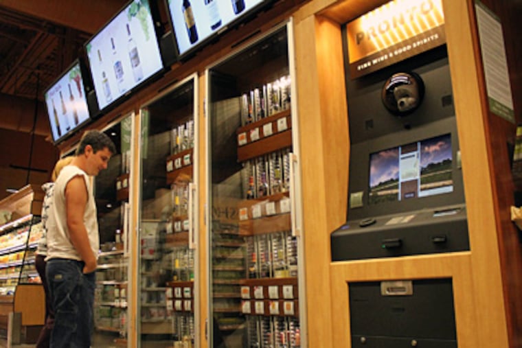 While the kiosks were operating, Jim Seibert and Kortney Zerphy pondered the wine selection at a Wegmans in Mechanicsburg. The dispensing area was equipped with a breath analyzer. (Evan Trowbridge / Staff)