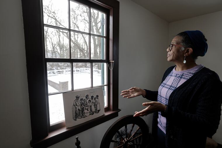 Lawnside Historical Society president Linda Shockley stands in the Peter Mott House to show the proximity of the New Jersey Turnpike (just beyond the tree line) in Lawnside, N.J.