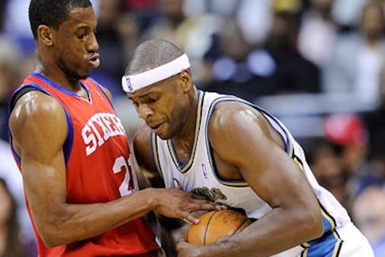 Washington's Brendan Haywood tries to drive past Thaddeus Young during the first half. (Nick Wass/AP)