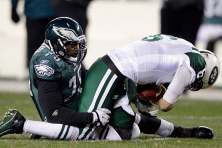 Juqua Parker drags down Jets' QB Mark Sanchez for a sack during the second half of Sunday's game. (Matt Slocum/AP Photo)