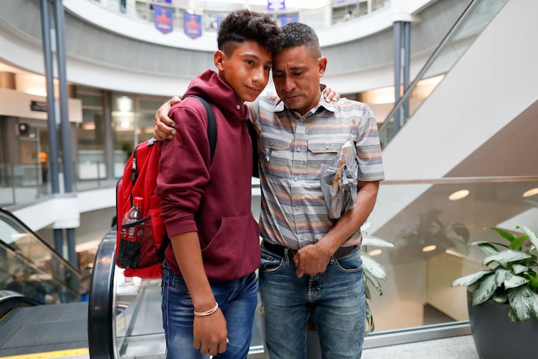 Edvin Cazun, of Guatemala, right, hugs his son Samuel at Cincinnati/Northern Kentucky International Airport as they reunite Monday after being separated about a month ago at the southern border. Edvin said he spent 15 days without knowing anything about his son.
