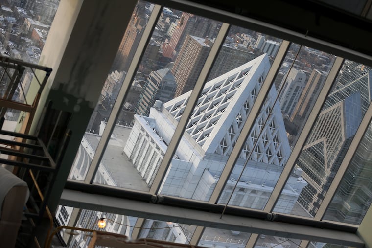 The BNY Mellon Center is reflected in an array of shiny panels hanging from the ceiling of the Comcast Technology Center's 60th floor, which will be part of the Four Seasons hotel.