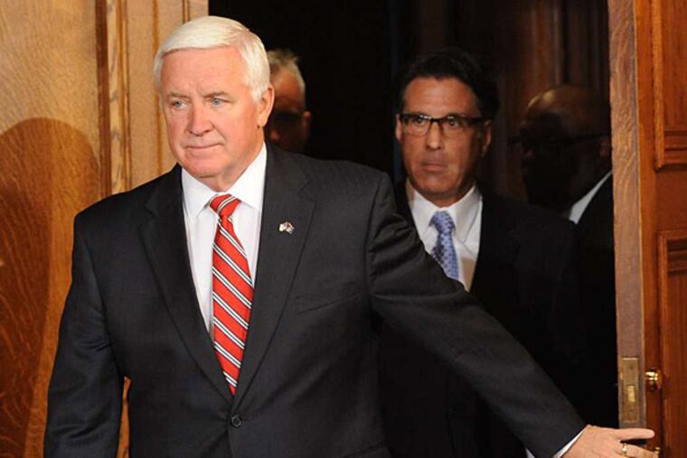 Gov. Corbett arrives at a press conference to discuss his signing and line-item vetoes of the state budget Thursday in Harrisburg. (Bradley C. Bower/AP)