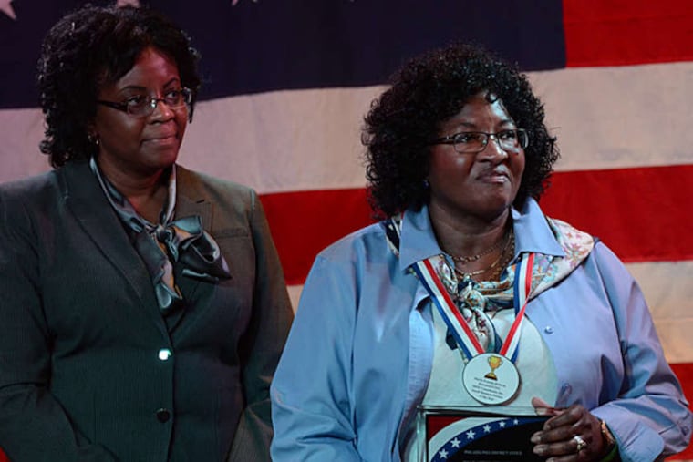 Maria Frizelle Roberts (right) with sister Sandra during presentation of her Small Business Person of the Year award.