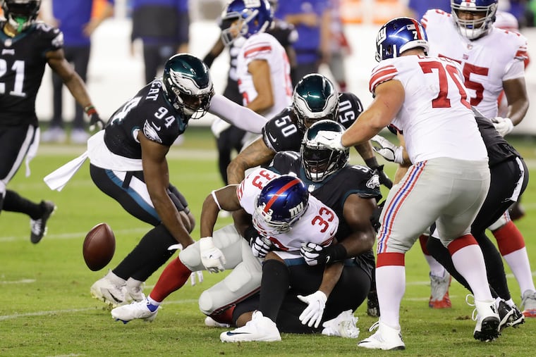 Giants running back Dion Lewis fumbles the ball against Eagles defensive tackle Fletcher Cox in the second quarter.