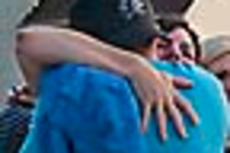 A vigil for slain Montco police officer Bradley Fox outside his Gilbertsville, PA home on Sept. 14, 2012. Here, friends and neighbors greet each other as they arrive at the home for the vigil. APRIL SAUL / Staff Photographer