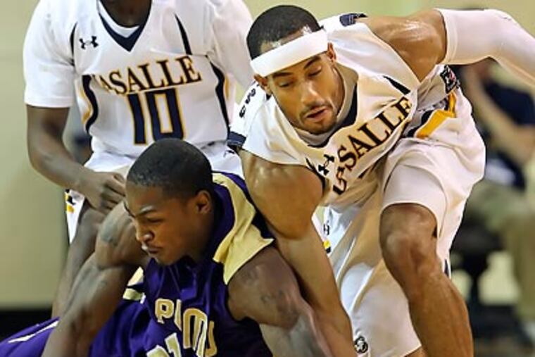 La Salle's Jerrell Williams collides with Prarie View A&M's Beloved Rogers during the first half. (Steven M. Falk/Staff Photographer)