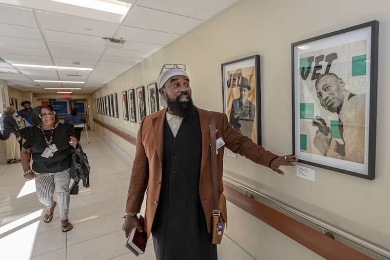 Hospital chaplain Robert Harcum takes a closer look at a reimagined JET magazine cover featuring renowned artist Horace Pippin, at Jefferson Einstein Hospital on Sept. 8, 2025. The piece is part of a show by North Philadelphia graphic artist Shaheed Rucker.