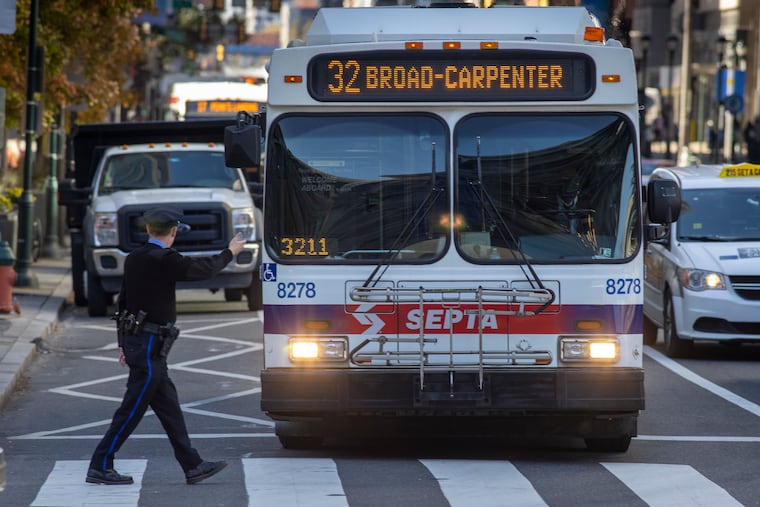 Philadelphia police officer Robert Blake controlling the flow of traffic along Market Street at 15th during traffic signal malfunction, Tuesday, November 9, 2021.