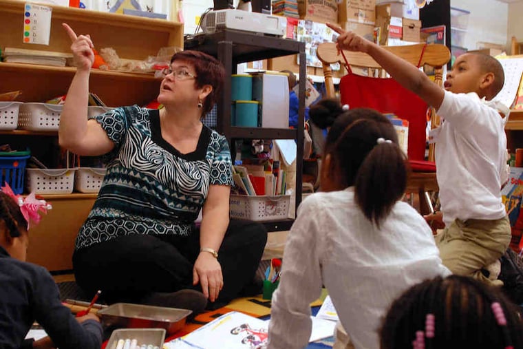 Teacher Hollie Citerone works with students including Laquan Lattimore (right) in her full-day kindergarten class in the Southeast Delco School District.