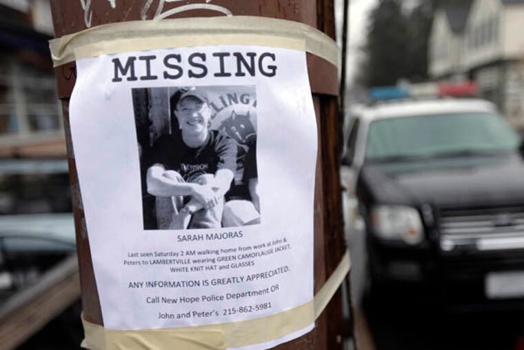 A poster for missing person Sarah Majoras is posted on Main Street, Monday, Jan. 28, 2013, in New Hope, Pa. The Hunterdon County Prosecutor's Office says 39-year-old Majoras had left a bar in New Hope, Pa., and was last seen crossing the bridge into Lambertville, N.J., at 2 a.m. Saturday. A search of the Delaware River by divers and by volunteers on land has failed to find a sign of the woman. (AP Photo/Matt Rourke)
