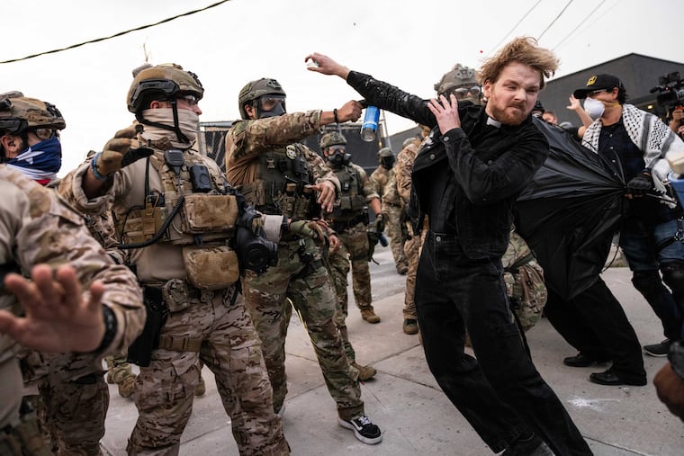 A federal immigration enforcement agent sprays the Rev. David Black, of the First Presbyterian Church of Chicago, as he demonstrates outside the U.S. Immigration and Customs Enforcement facility in Broadview, Ill., in September.