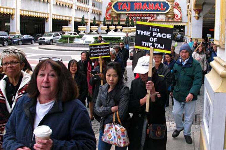 Workers at the Trump Taj Mahal Casino Resort in Atlantic City, N.J. march to City Hall on Monday, Nov. 3, 2014 to deliver a petition to Mayor Don Guardian asking for help in keeping the struggling casino open. The mayor has already rejected the request from Trump Entertainment resorts, noting the city has already given the company two recent reductions and cannot afford a third. The company is threatening to close the Taj Mahal in December if a package of city or state is not approved soon. (AP Photo/Wayne Parry)