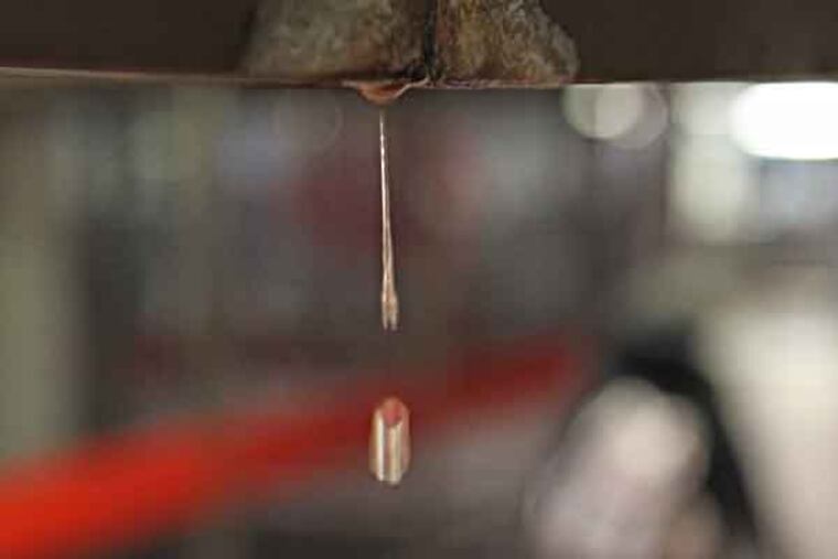 The water is a constant drip, drip, drip, from a leaking, corroding duct at the 8th and Market SEPTA concourse. The constant presence of buckets and wet-floor warning signs beneath a constantly dripping ceiling with a hole in it, by the transit map just outside the Inquirer's concourse-level door.
( MICHAEL BRYANT / Staff Photographer )