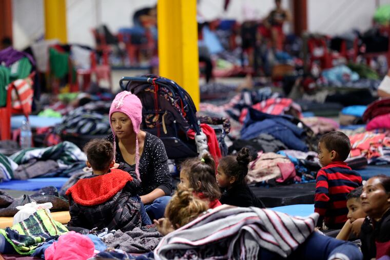 Honduran Delia Romero, 24, sits with her children in their sleeping area at a sheltered in Piedras Negras, Mexico, Tuesday, Feb. 5, 2019. A caravan of about 1,600 Central American migrants camped Tuesday in the Mexican border city of Piedras Negras, just west of Eagle Pass, Texas. The governor of the northern state of Coahuila described the migrants as "asylum seekers," suggesting all had express intentions of surrendering to U.S. authorities. (Jerry Lara / San Antonio Express-News via AP)
