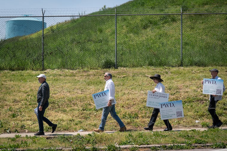 (Left to Right) Hilary Langer, chairman of the East Falls Community Council zoning committee, Paul Elia, Frances Bourne, and Bill Hoffner, shown here next to the Queen Lane Water Treatment plant, in Philadelphia, Monday, April 29, 2024.