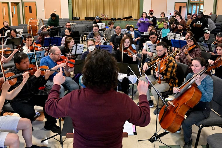 Josh McHugh conducts in the foreground as members of The Greater Philadelphia Gamer Symphony Orchestra rehearse in Roxborough on Monday May 11th.