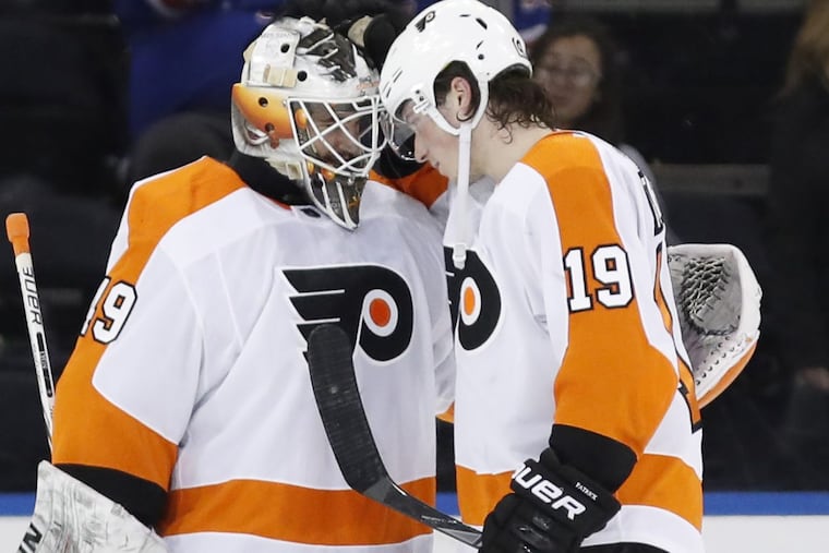 Philadelphia Flyers goalie Alex Lyon (left) gets congratulated by Nolan Patrick after the goalie’s first NHL win Sunday at the New York Rangers.