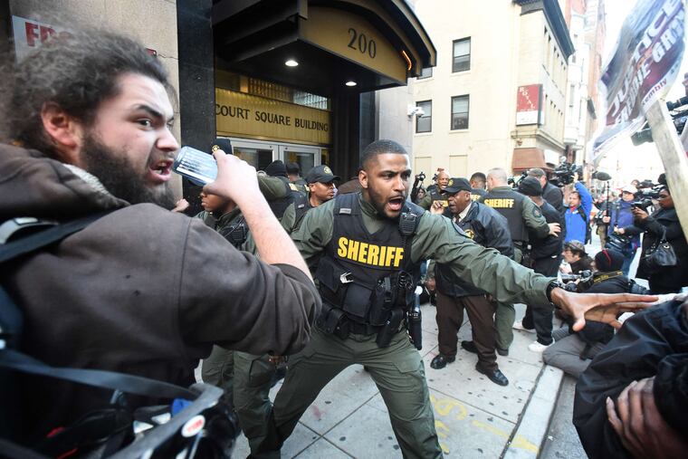 Baltimore sheriff's deputies try to secure the courthouse area after the judge declared a mistrial.