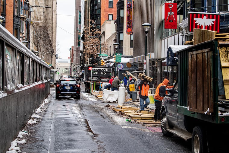 Workers removing streeteries along 13th Street near Sansom in Center City on Jan. 7, 2022.