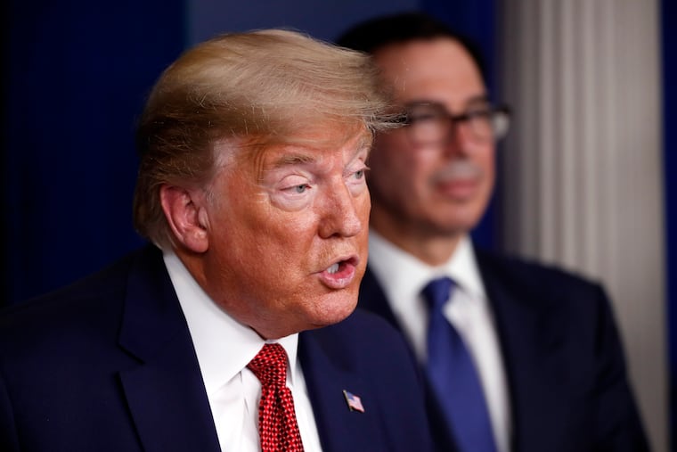 President Donald Trump speaks about the coronavirus in the James Brady Briefing Room on Wednesday in Washington as Treasury Secretary Steven Mnuchin listens.